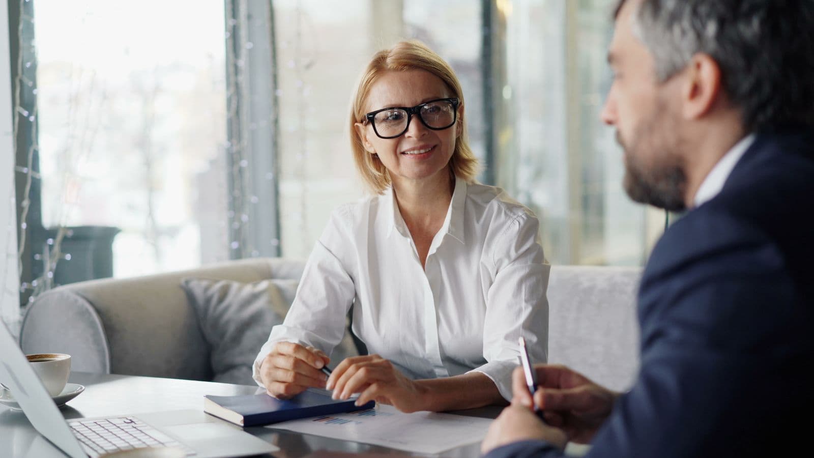 A coach and client in conversation during a professional coaching session